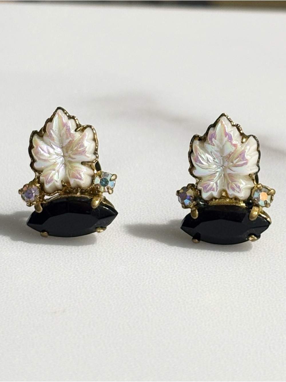 West Germany Black Faceted & Iridescent White Leaf Rhinestone Clip Earrings